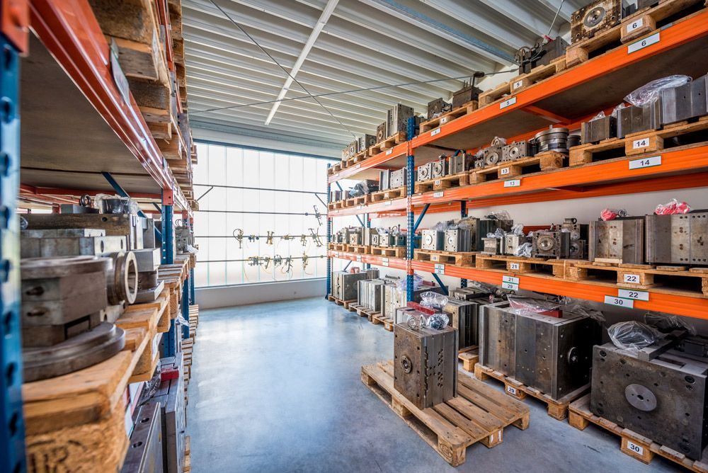A close-up of a well-organized warehouse with shelves stocked with various industrial spare parts.